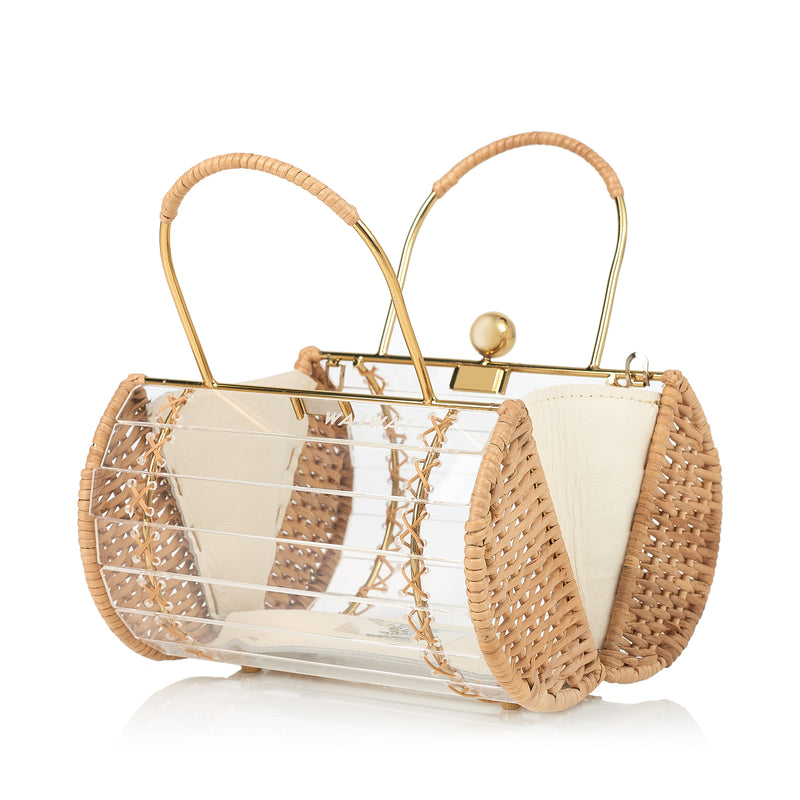 Bolsa box estruturada em acrílico transparente com laterais em rattan, detalhe de costura em X dourado, alça rígida metálica com revestimento em rattan e fecho esférico dourado.
