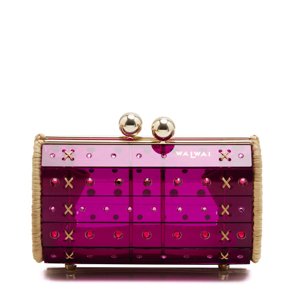 Clutch estruturada em rattan com corpo em acrílico roxo translúcido, aplicação de cristais circulares e fecho metálico dourado no topo.