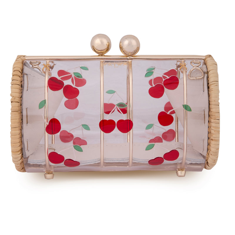 Clutch estruturada em rattan com corpo em acrílico transparente, estampa divertida de cerejas vermelhas com folhas verdes e fecho metálico dourado no topo.